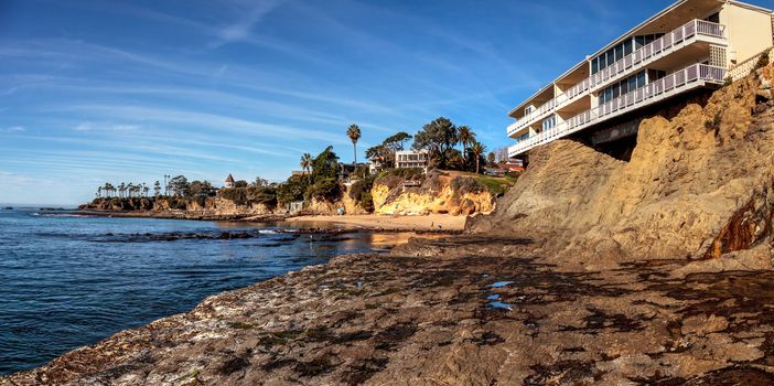 Blue sky over Diver’s Cove Beach with the ocean at low tide in Laguna Beach, California, USA in winter