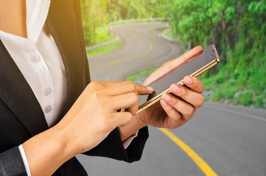 Business woman using mobile smart phone on s curve road, Transportation business concept.
