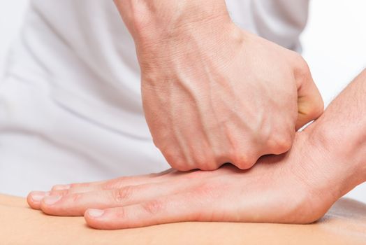 pushing against sports massage, masseur's hands closeup