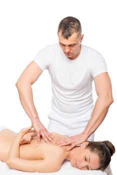young professional masseur with the patient on a massage table