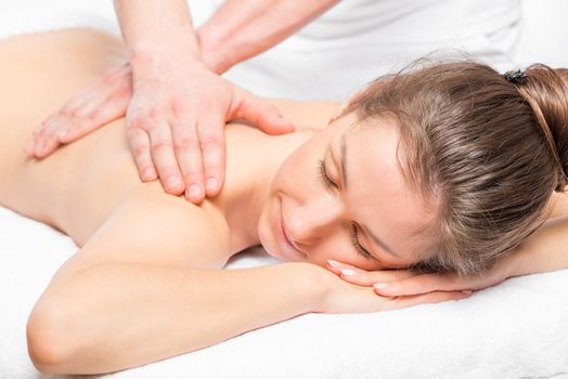 happy girl relaxed on a massage table during the massage