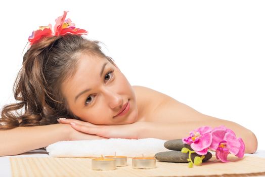 beautiful serene brunette on massage table at spa cabinet