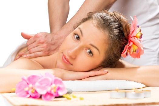 girl with flowers in her hair on a massage table from a professional