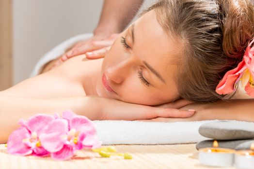 portrait of a girl with closed eyes during the massage in the spa cabinet