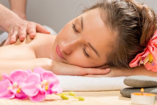 Horizontal portrait of a young woman closeup a massage at the spa