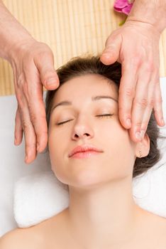 Beautician doing a facial massage, top view