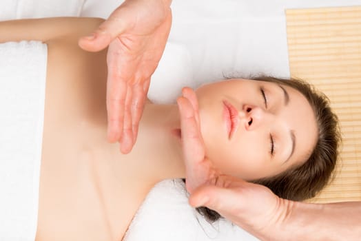 beautician movement of hands to massage the neck and face close-up