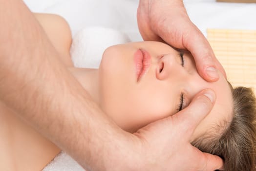 girl's face close-up and massage the skin of the forehead