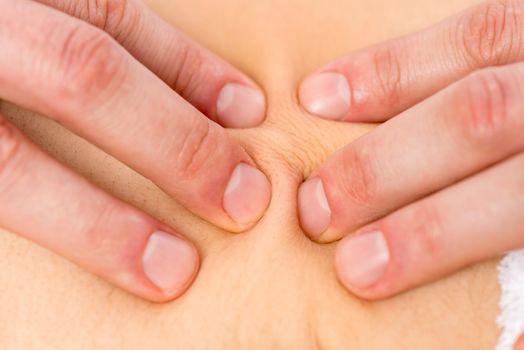 fingers masseur on the patient's skin close up