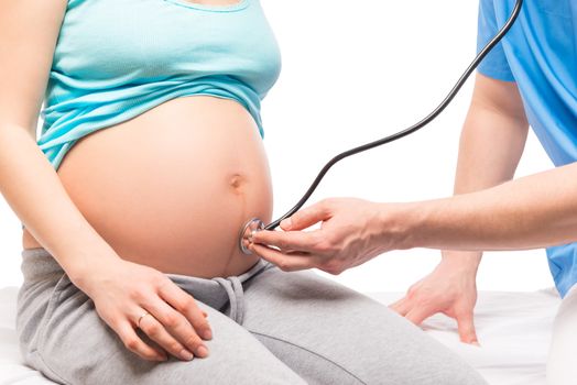 Pregnant woman on reception at the gynecologist, belly closeup