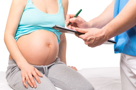 Doctor writes in folder information about the health of the pregnant woman