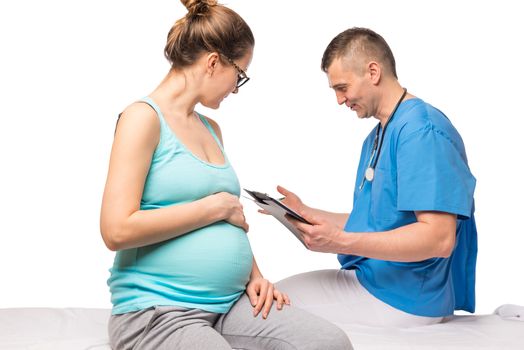 Healthy pregnant woman at examination in doctor-gynecologist