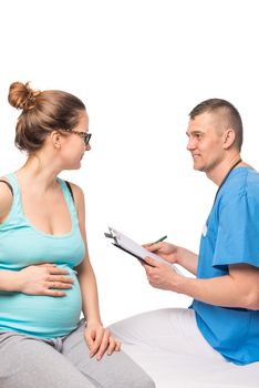 beautiful pregnant woman on reception at the doctor of the therapist to expectant mothers