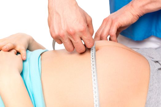 examination of a pregnant woman Doctor measures the volume of the stomach