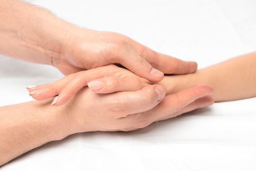female hand in male hands closeup, stroking massage