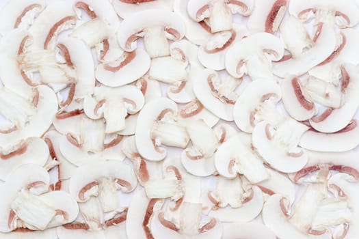 Background of chopped fresh uncooked button mushrooms into thin slices 
