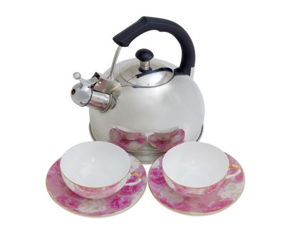 Stainless steel kettle with a whistle and two pink porcelain cups with saucers on a light background
