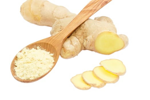 Ginger powder in a wooden spoon and a few slices of a fresh ginger against the backdrop of ginger root on a light background
