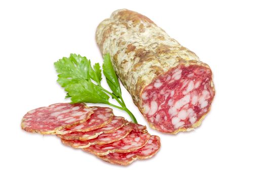 Italian salami, some sliced thin slices of salami and sprig of parsley  on a light background
