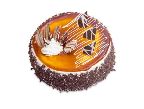 Round sponge cake, covered with jelly and decorated with whipped cream and slices of black chocolate and milk chocolate on a light background
