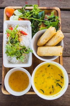 noodle and curry sauce with vegetable on wood table