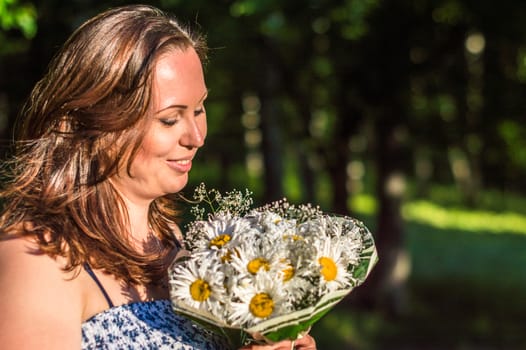 woman with a bouquet of daisies in the Park
