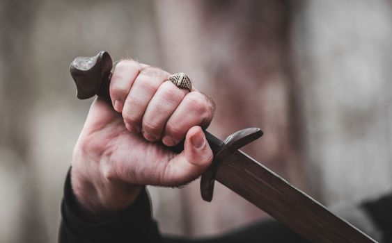 antique sword in the man's hand close-up