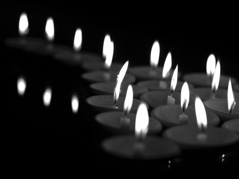 BLACK AND WHITE PHOTO OF OFFERING LIT CANDLES