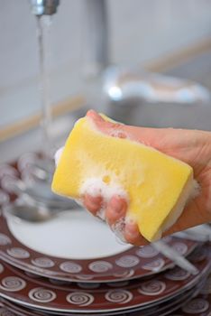 Washing the dishes on the kitchen sink