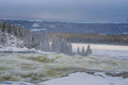 Tannoforsen waterfall in Sweden, does not freeze in the winter the water falls from a height of between stones