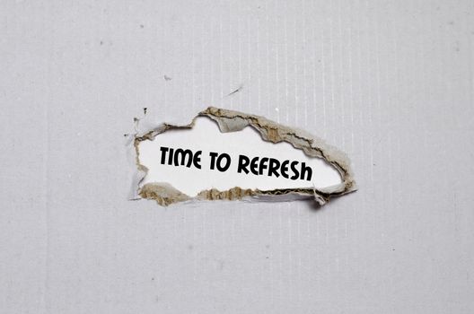 The word time to refresh appearing behind torn paper