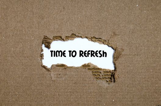 The word time to refresh appearing behind torn paper