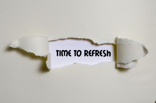 The word time to refresh appearing behind torn paper