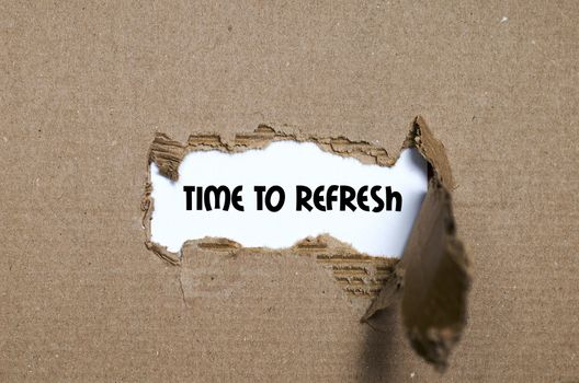 The word time to refresh appearing behind torn paper