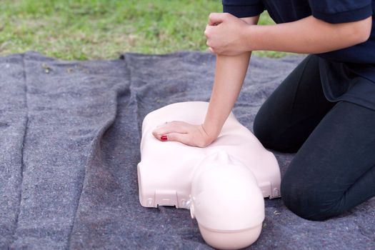 Paramedic demonstrate Cardiopulmonary resuscitation (CPR) on training doll. Heart massage.