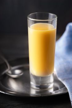 Egg liqueur on the dark background vertical