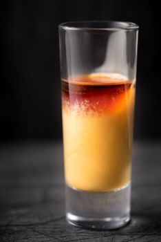 Cocktail of egg and cherry liqueur on the dark background