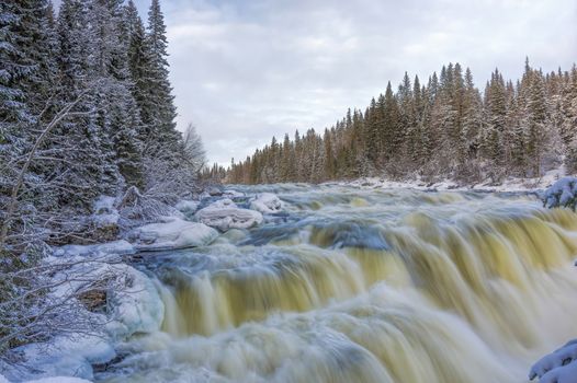 Tannoforsen waterfall in Sweden, does not freeze in the winter the water falls from a height of between stones