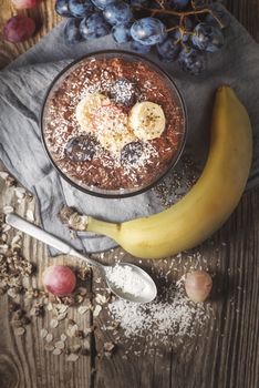 Chocolate chia pudding with fruits on the wooden table  top view