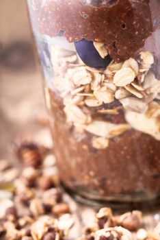 Chocolate chia pudding with oat flakes in the glass jar