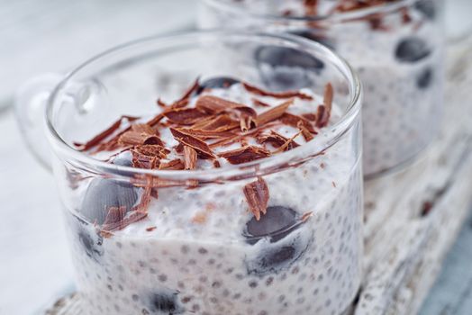 Chia pudding with grapes and chocolate flakes on the glass cup horizontal