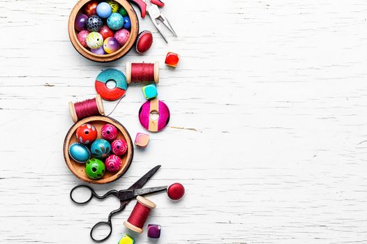 different loose beads for jewelry and pliers on light background