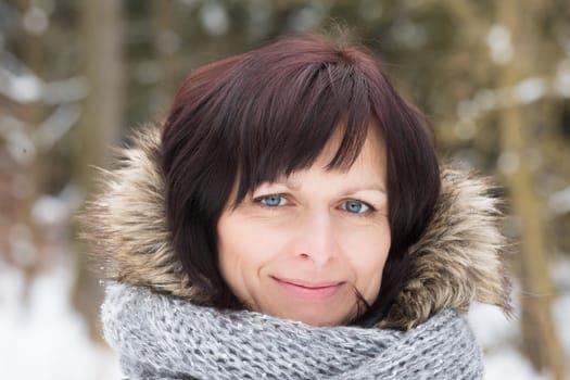 portrait of happy smiling middle age woman without makeup in winter time