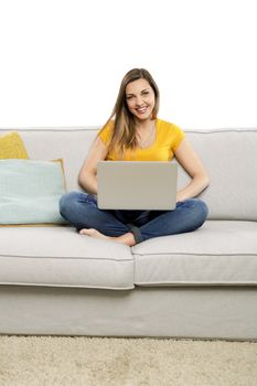 Beautiful woman at home working with her laptop