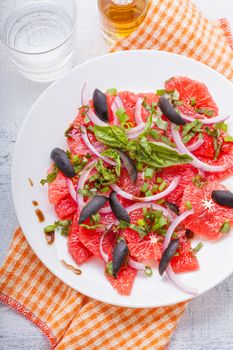 Grapefruit salad with olives red onion, basil