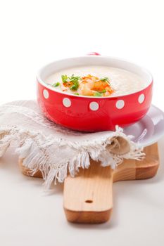 A bowl of creamy cauliflower soup with shrimps