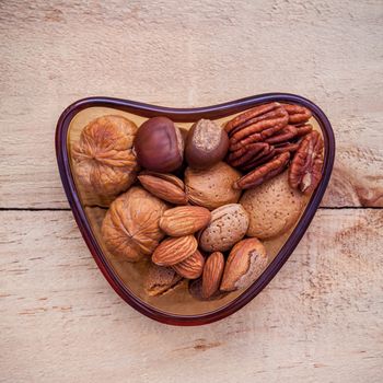 Selection food sources of omega 3 and unsaturated fats. Super food high vitamin e and dietary fiber for healthy food. Almond ,pecan ,hazelnuts and walnuts on wooden background flat lay.