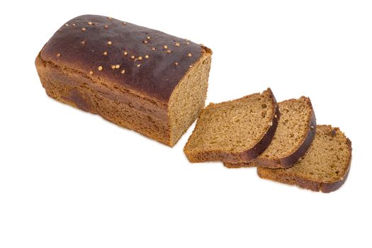 Part of loaf brown bread from rye and wheat flour sprinkled with coriander seeds and several slices of bread on a light background
