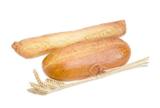 Fresh baguette, wheat bread and bundle of wheat ears on a light background
