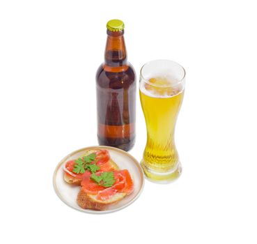 Beer glass with lager beer, bottle beer and two sandwiches made with a salted trout on a light background
